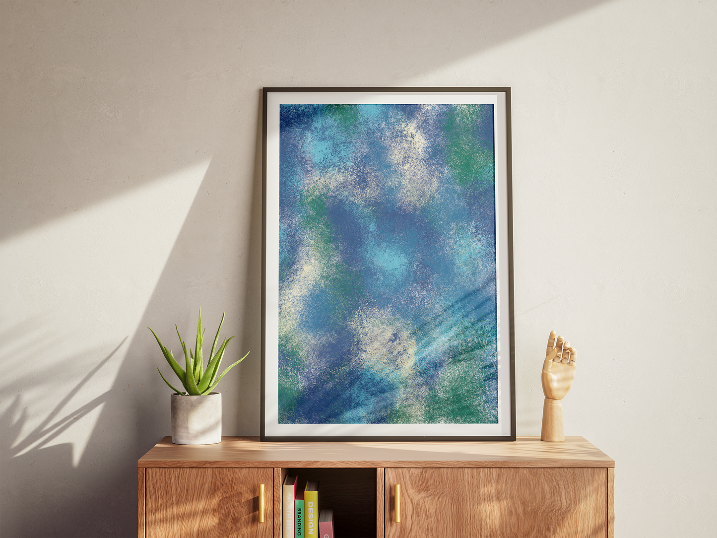 Digitally crafted abstract free painting with a vibrant blend of blue and green, giving the impression of a misty seascape, elegantly framed and featured in a light-filled eco-conscious living room.