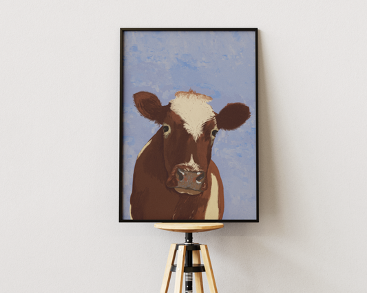 Hand-painted digital art print of a brown cow with a white blaze, presented on a wooden easel for an artistic touch in a room with parquet flooring