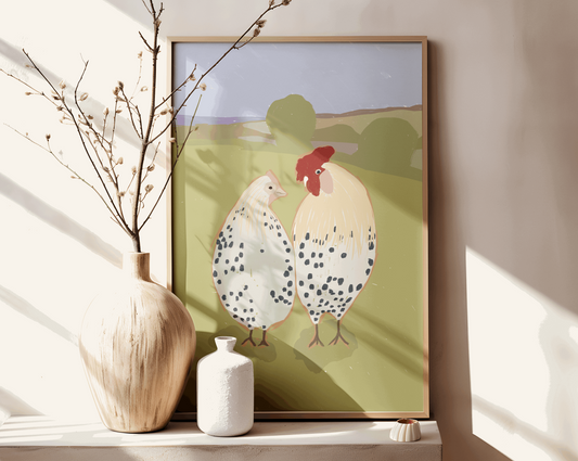 Charming wall art featuring chickens in a field, propped on a wooden console table with a large beige vase and white pottery in a sunlit room.