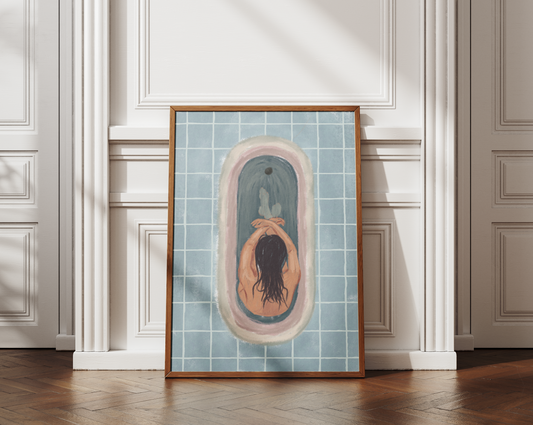 Printable digital art piece leaning against an elegant white wainscoting wall, featuring a relaxing scene of a woman in a tiled bathtub