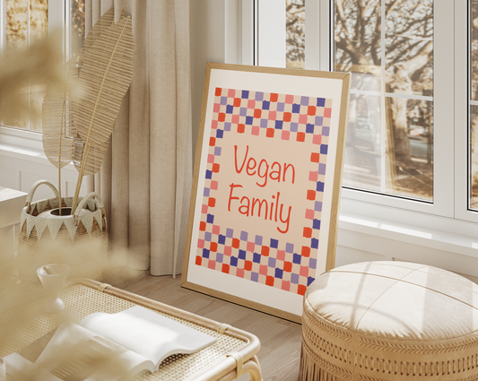A tranquil window-side setting featuring a printable 'Vegan Family' digital painting with a vibrant checkered design, reflecting a lifestyle choice