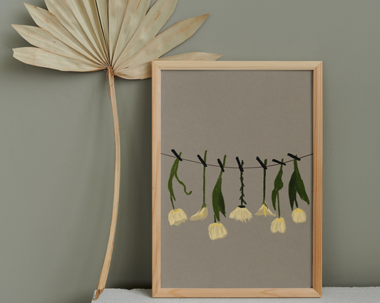 A minimalist digital artwork depicting white hanging flowers, framed in light wood, set against a muted wall beside a dried palm leaf fan
